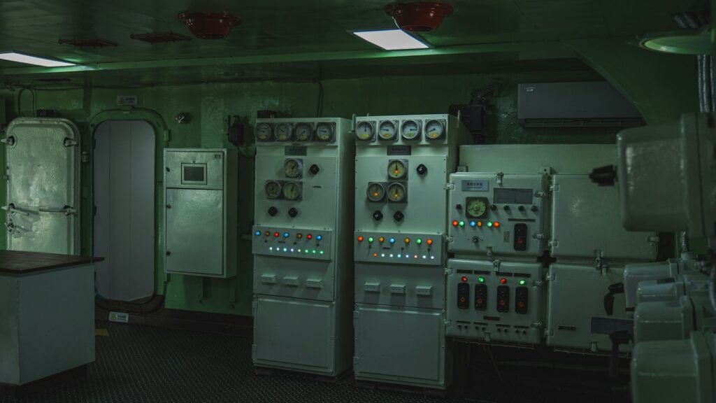 غرفة تحكم بلوحات كهربائية وعدادات | Control room with electrical panels and gauges
